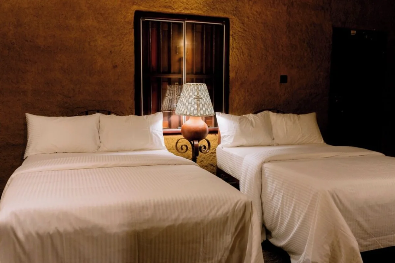 Two double beds side by side in the Economy Quadruple Cottage