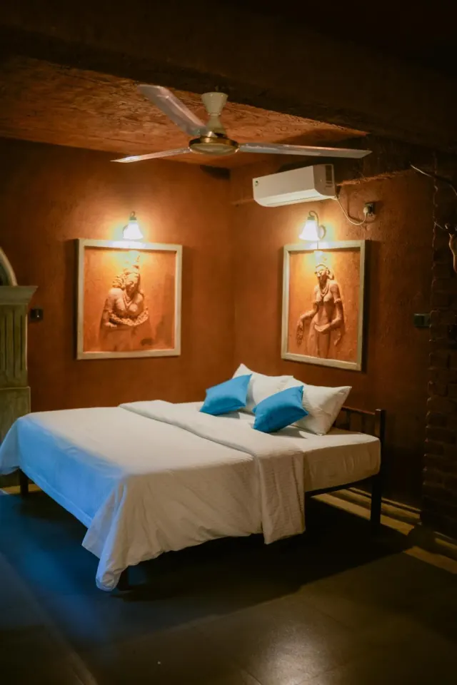 A ceiling fan and air conditioning over the bed in the Quadruple Family Cottage