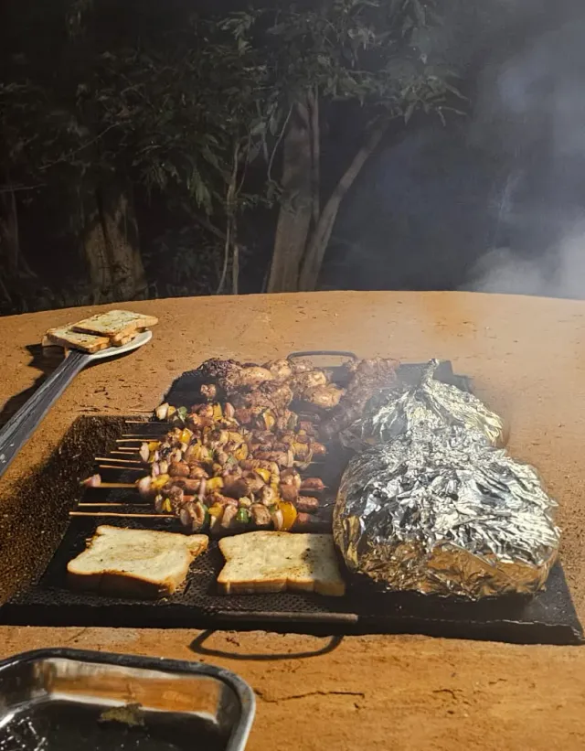 Bread and foil parcels on the barbecue grill at dinner