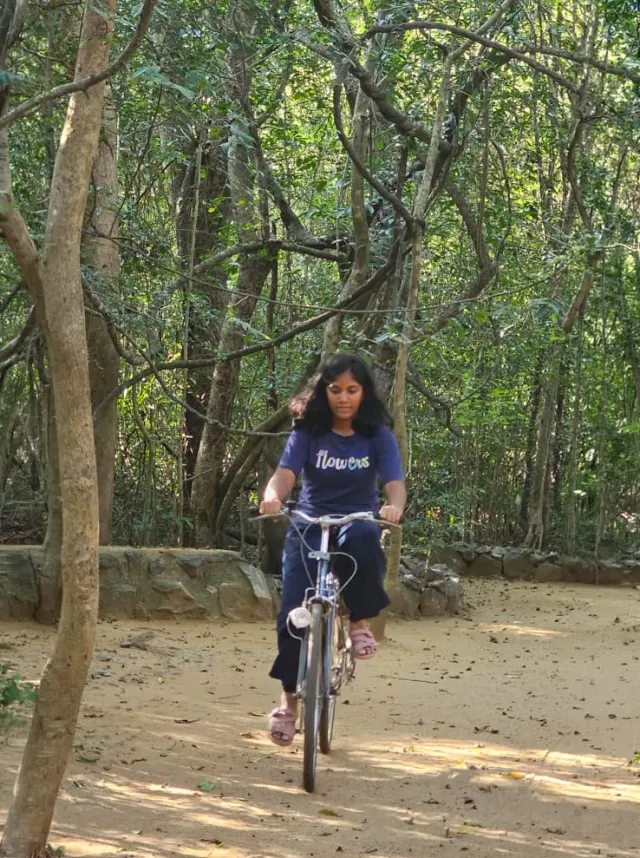 A guest cycling the sand path through the forest