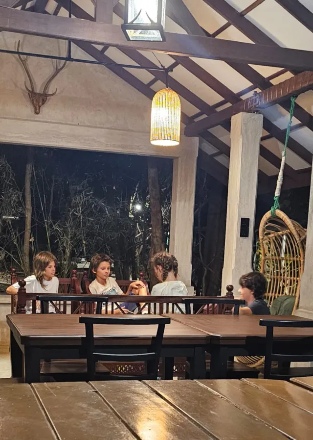 Dinner in the pavilion after dark, with the hanging chair and lanterns