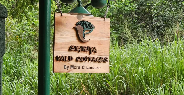 The wooden sign at the gate