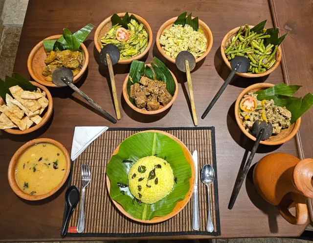 Rice and curries in clay bowls on banana leaves, laid for lunch
