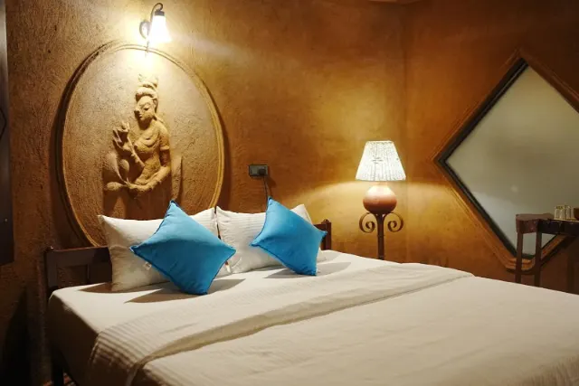 A cottage bedroom with a carved figure in an oval panel
