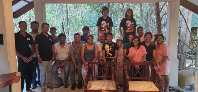 The team and a visiting group together in the dining pavilion